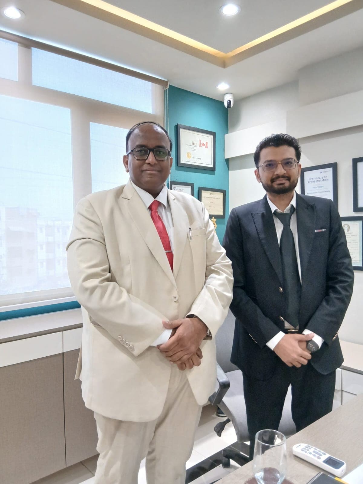 Ghulam Shabbir Babar with a colleague in an office